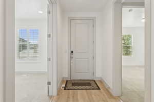 Foyer featuring baseboards and light wood-style floors