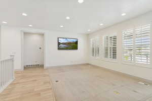Family room featuring recessed lighting and light wood-style floors.