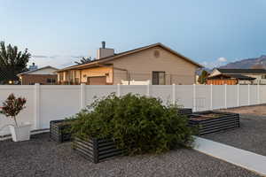 Fenced backyard with a vegetable garden boxes