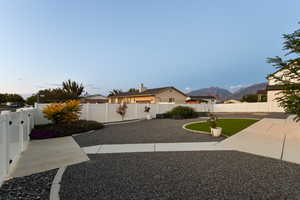 Fenced backyard featuring a mountain view and a patio area