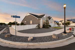 View of front of home with stone siding and a garage