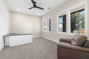 Living area with light colored carpet, recessed lighting, and ceiling fan