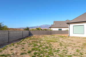 Fenced backyard featuring a mountain view