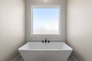 Full bathroom with a freestanding bath and plenty of natural light