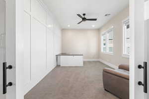 Sitting room featuring light colored carpet, recessed lighting, and a ceiling fan