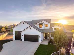 Modern farmhouse style home featuring a garage, concrete driveway, brick siding, and a tile roof