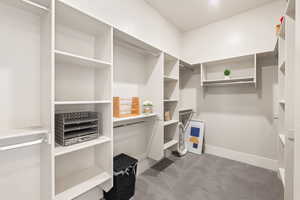 Walk in closet with dark carpet