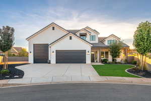 Modern farmhouse with driveway, an attached garage, and brick siding