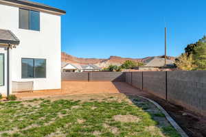 Fenced backyard featuring a mountain view