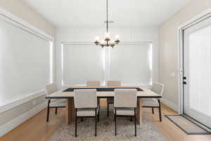 Dining room featuring light wood-style flooring and a chandelier