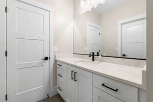 Bathroom featuring vanity and dark tile patterned floors