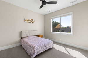 Carpeted bedroom with baseboards and ceiling fan