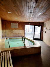 View of swimming pool with an in-ground hot tub