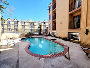 Community pool featuring a patio