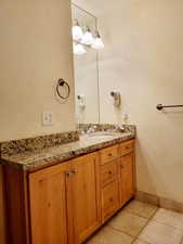 Bathroom featuring vanity and baseboards