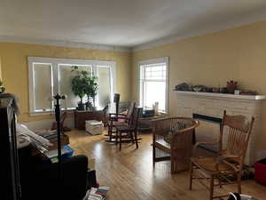 Sitting room featuring a stone fireplace and hardwood / wood-style floors