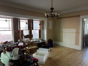 Dining area with wood-type flooring and a chandelier