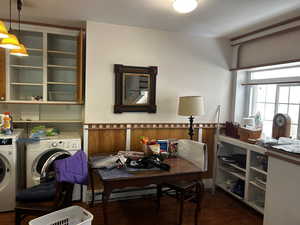 Kitchen featuring dark wood-type flooring and separate washer and dryer