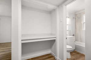 Bathroom with  shower combination, dark wood finished floors, and vanity