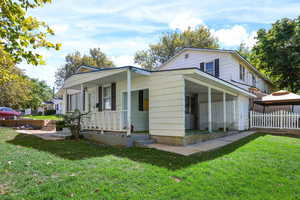 View of side of home featuring covered porch