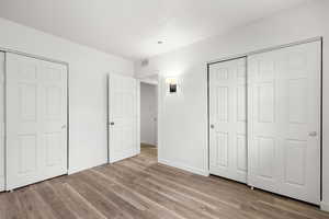 Unfurnished bedroom featuring light wood-style flooring