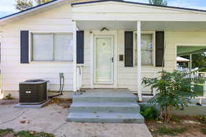 Doorway to property with covered porch