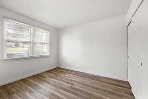 Unfurnished bedroom featuring a closet and wood finished floors