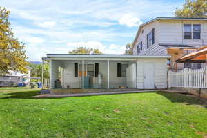 Rear view of house featuring covered porch