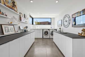 Laundry room with cabinet space, recessed lighting, and washer and clothes dryer