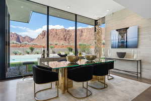 Dining room featuring a wall of windows, a mountain view, and recessed lighting