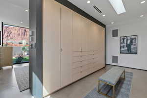 Living area with recessed lighting, a skylight, and concrete floors