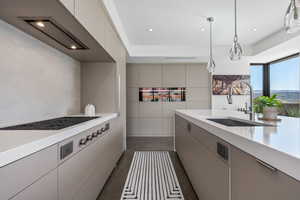Kitchen featuring decorative light fixtures, gray cabinets, modern cabinets, stainless steel gas stovetop, and recessed lighting