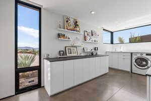 Laundry room with washer / dryer and recessed lighting