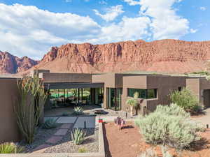Rear view of property featuring a mountain view and stucco siding