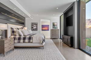Bedroom featuring recessed lighting, finished concrete floors, and access to exterior