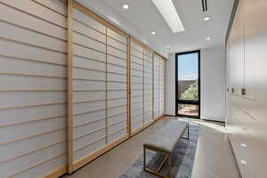 Interior space featuring recessed lighting, concrete flooring, and a wall of windows