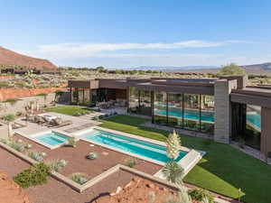 Swimming pool with a mountain view, a patio, and an in-ground hot tub