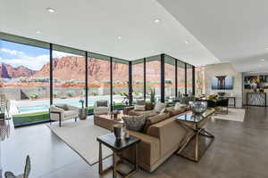 Common area with floor to ceiling windows, recessed lighting, and a mountain view