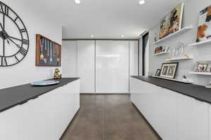 Hall featuring recessed lighting and concrete floors