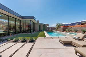 View of swimming pool featuring a fenced backyard, a mountain view, and a patio area