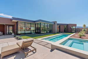 Swimming pool featuring an in-ground hot tub, a patio area, and a mountain view