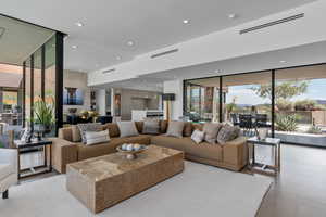 Living room featuring floor to ceiling windows, plenty of natural light, and recessed lighting
