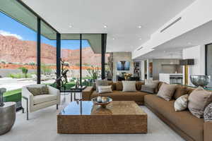 Living area with expansive windows, a mountain view, and recessed lighting