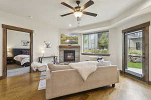 Living area with hardwood / wood-style flooring, a fireplace, recessed lighting, and a ceiling fan