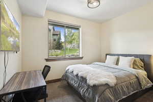 Bedroom featuring carpet floors and baseboards