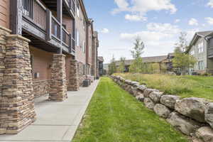 View of property's community featuring a yard and a residential view
