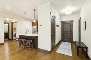 Foyer entrance with light wood-style floors and washer / dryer