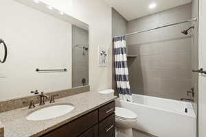 Full bathroom featuring shower / bath combination with curtain and vanity
