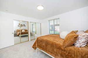 Bedroom featuring two closets and carpet