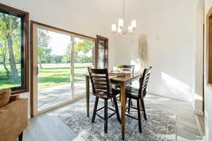 Dining area featuring light wood-style floors and a chandelier